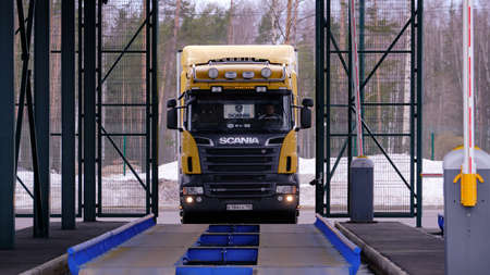 St. Petersburg, Russia - March 22, 2019: The barrier gate of the customs post is open. A Scania wagon enters the weighing control platform.のeditorial素材