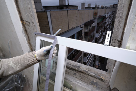 Installing a new plastic window. The specialist will attach a thick foam tape that serves to...