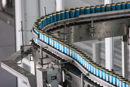 St. Petersburg, Russia - June 21, 2006: Production line of the brewery. There are blue aluminum jars on the conveyor.のeditorial素材