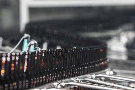 St. Petersburg, Russia - June 21, 2006: Production line of the brewery. Empty glass brown dark bottles on the conveyor.のeditorial素材