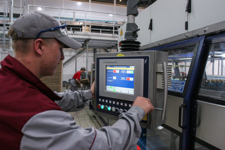 St. Petersburg, Russia - June 21, 2006: Production line of the brewery. A specialist engineer enters...