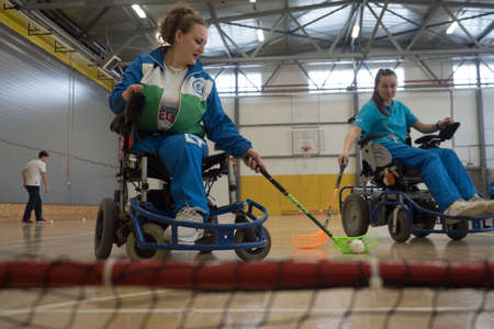 St. Petersburg, Russia - February 9, 2019: Young female sportswomen in wheelchairs prepare for competitions in the gym. Optimism, cheerfulness, stamina, excitement, the moment of the gameのeditorial素材