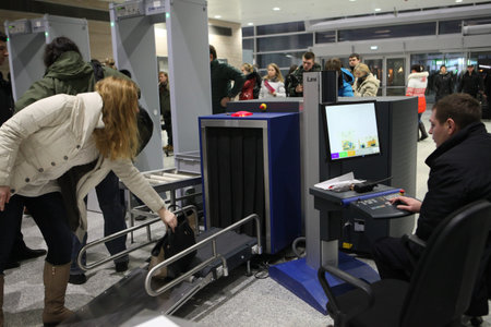 St. Petersburg, Russia - December 3, 2013: An airport employee scans things of passengers at Pulkovo...