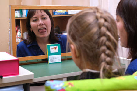 St. Petersburg, Russia - February 27, 2020: A speech therapist specialist conducts speech correction classes in a children's preschool specialized institution. The correct pronunciation of soundsのeditorial素材