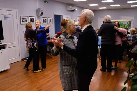 St. Petersburg, Russia - September 26, 2018: social municipal house for elderly people daytime stay. Entertaining event. Dance, round danceのeditorial素材