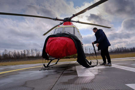 St. Petersburg, Russia - March 11, 2020: Helicopter of the national air ambulance service on the take-off platform in preparation for the departureのeditorial素材