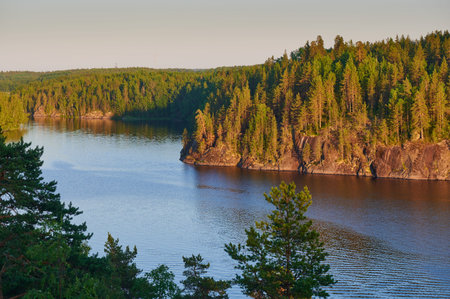 Beautiful landscape view of the Saymensky canal. Navigable canal between Lake Saimaa in Finland and Vyborg Bay in Russia. Point shooting squirrel rocks. Smooth water surface. Afternoon in the late の写真素材