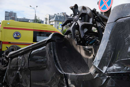 Saint Petersburg, Russia - July 21, 2020: Cherokee SUV jeep inverted after a severe road collision in the city. Firefighters eliminate gas tank explosion threatのeditorial素材