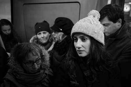 Saint Petersburg, Russia - February 8, 2019: Passengers in winter clothes in a crowded bus cabin. Public transport during rush hour. Many standing peopleのeditorial素材