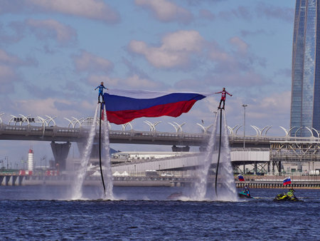 Saint Petersburg, Russia - June 12, 2020: Flyboarders show on the Neva river against the background...
