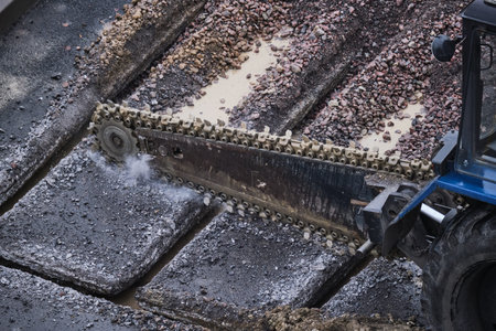 chain trench excavator, trencher, bar aggregate, soil cutter in the middle of cutting the road...