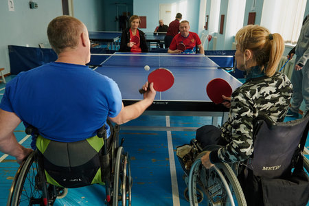 SAINT PETERSBURG, RUSSIA - FEBRUARY 11, 2021: Wheelchair users lead an active lifestyle, play table tennis, the moment of the game, ball serveのeditorial素材