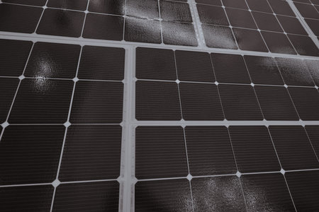 Flat surface of solar panels. Close-up square cells receiving sunlight.