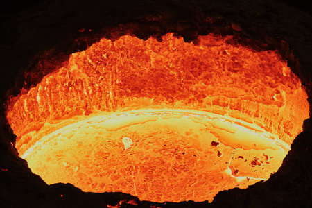 liquid molten steel in a bright red tank, similar to lava in a workshop in a metallurgical plant,...