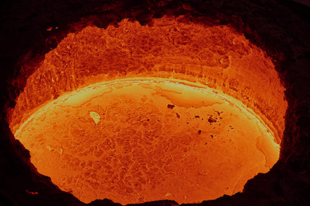 liquid molten steel in a bright red tank, similar to lava in a workshop in a metallurgical plant,...