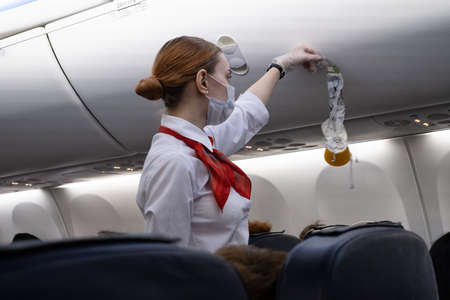 Stewardess of Nordwind Airlines instructs aircraft passengers before departureのeditorial素材