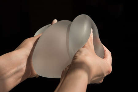 Silicone implant of the female breast during the demonstration of its quality.の写真素材
