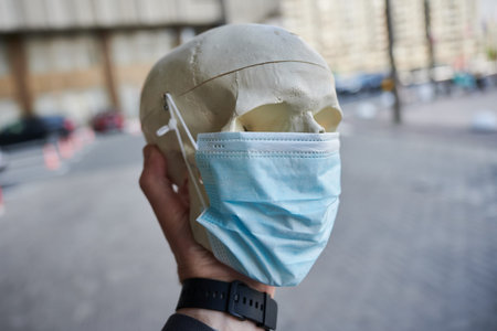 educational medical object human skull in a protective mask