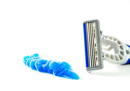 Closeup of blue shaving blade with foam on white surfaceの写真素材
