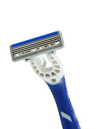 Closeup of blue shaving blade on white surfaceの写真素材
