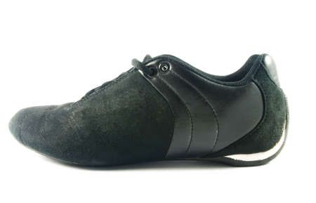 Black female sport shoe over white surfaceの写真素材