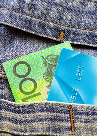 australian money and credit card in jeans pocket