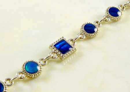 jewelry with blue stones on marble surfaceの写真素材