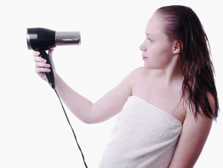 soft picture of girl after shower with hairdryerの写真素材