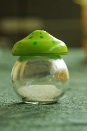 green glass salt bottle on tableの写真素材