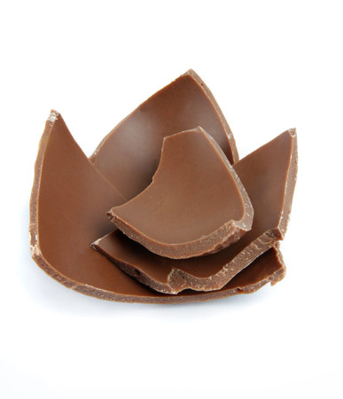 broken chocolate pieces over whiteの写真素材