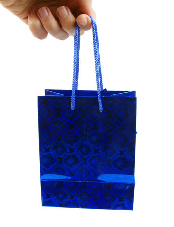 blue holiday gift bag in hand の写真素材