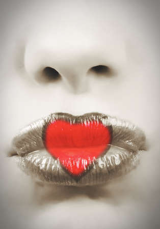 closeup of bright red lips with heart toned pictureの写真素材