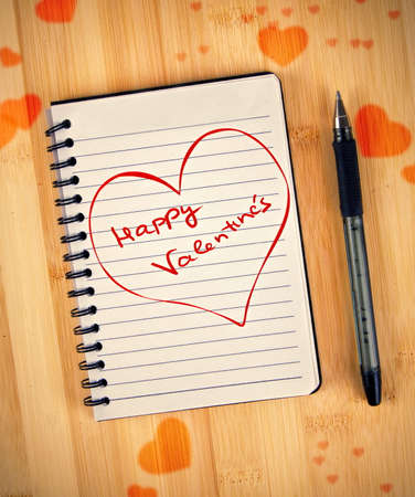 happy valentines written on notebookの写真素材