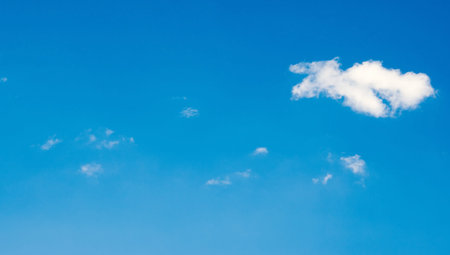 blue sky with one single cloudの写真素材