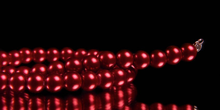 red pearl necklace on blackの写真素材