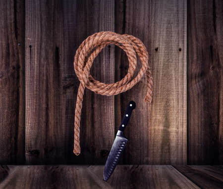 vintage rope with knife over wooden backgroundの写真素材