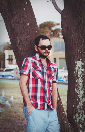 man with beard in the park with casual clothesの写真素材