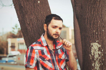 man with beard in the park with casual clothesの写真素材