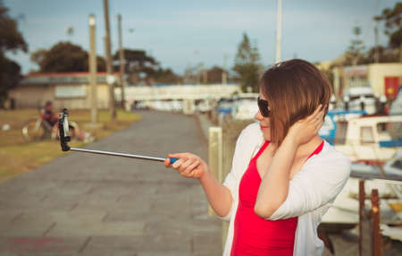 girl taking selfie picture outdoors,vintage effectの写真素材