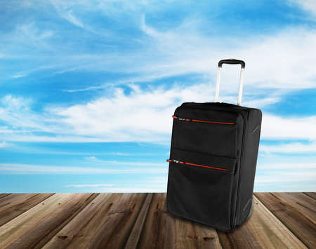 travel suitcase on wood textureの写真素材