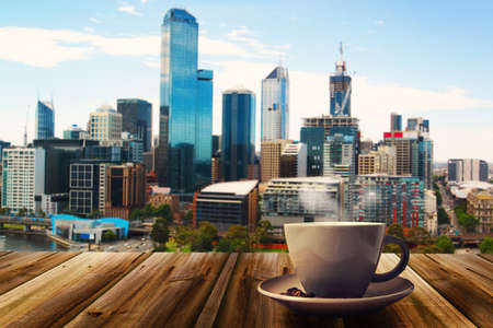 cup of coffe on abstract city backgroundの写真素材
