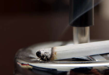 dark shot of cigarette in ashtrayの写真素材