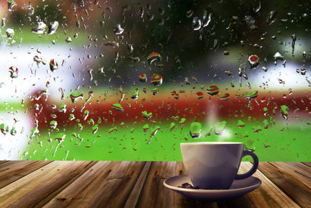 cup of coffee on rainy windowの写真素材