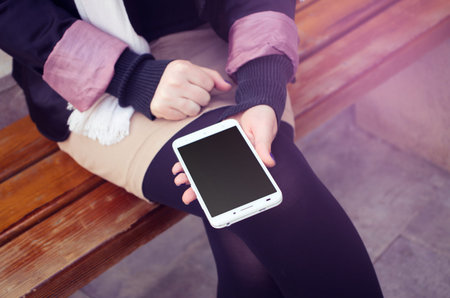 casual woman with phone outoors
