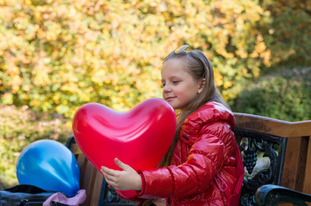 pretty girl in the autumn park with baloonsの写真素材