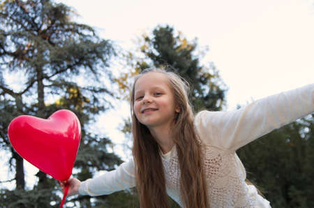 pretty girl in the autumn park with baloonsの写真素材