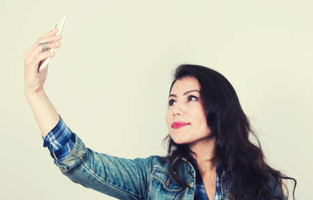 brunette girl taking selfieの写真素材