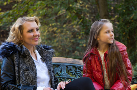 mother and daughter in the autumn parkの写真素材
