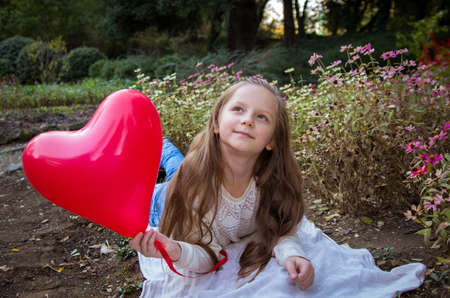pretty girl in the autumn park with baloonsの写真素材
