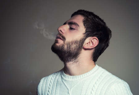 sad handsome man with cigaretteの写真素材